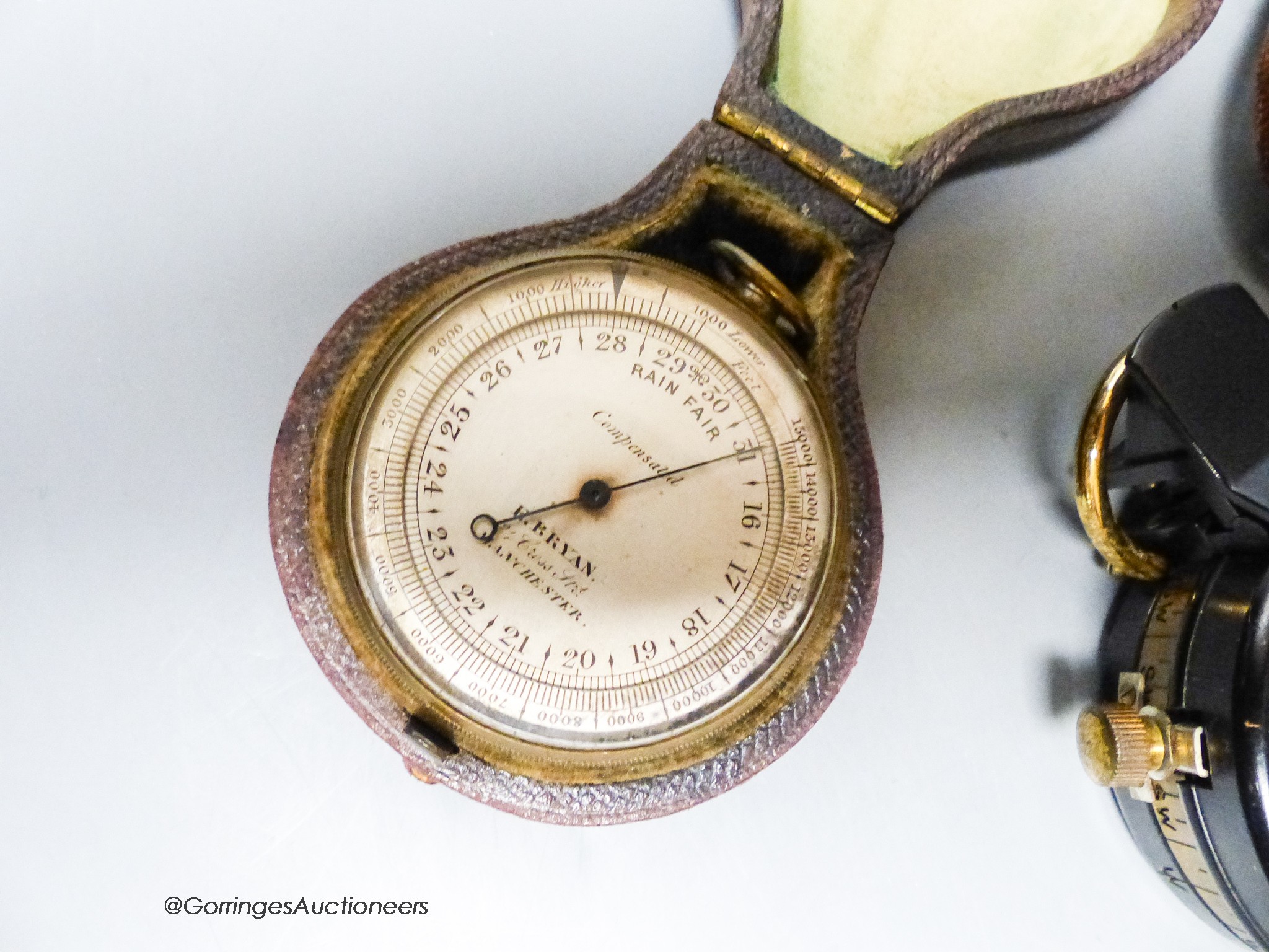 A small leather-cased military compass together with a cased compensated pocket barometer, E.Bryan, Manchester (2)